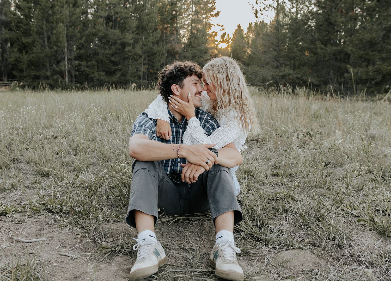 Candid couples engagement session in Island Park, Idaho in a field during the summer