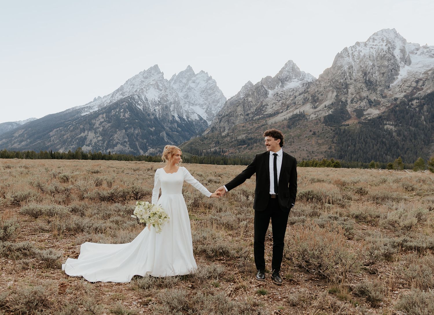 Wedding photos at Cascade Canyon overlook in Grand Teton National Park at sunset