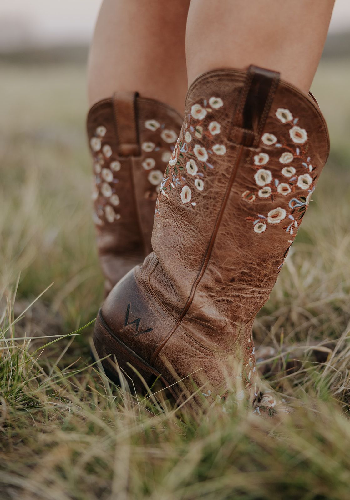 Cowgirl boots with an engraved initial