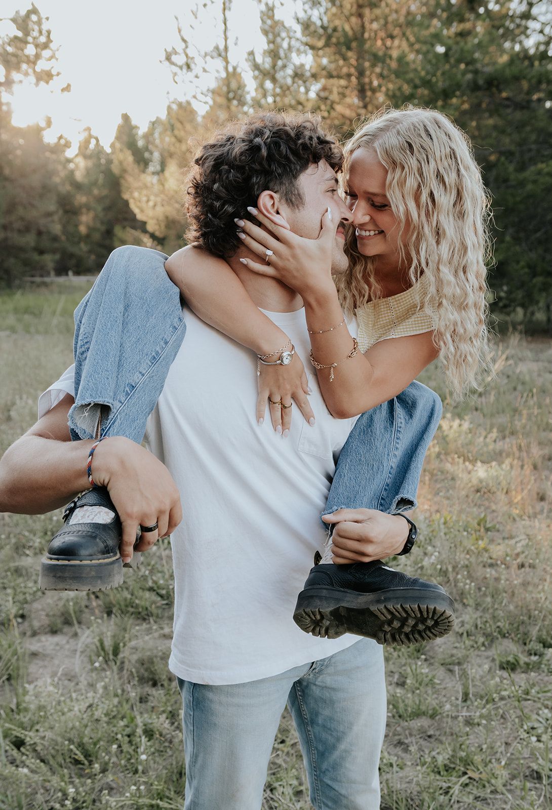 Candid couples engagement session in Island Park, Idaho in a field during the summer. Intimate engagement photoshoot