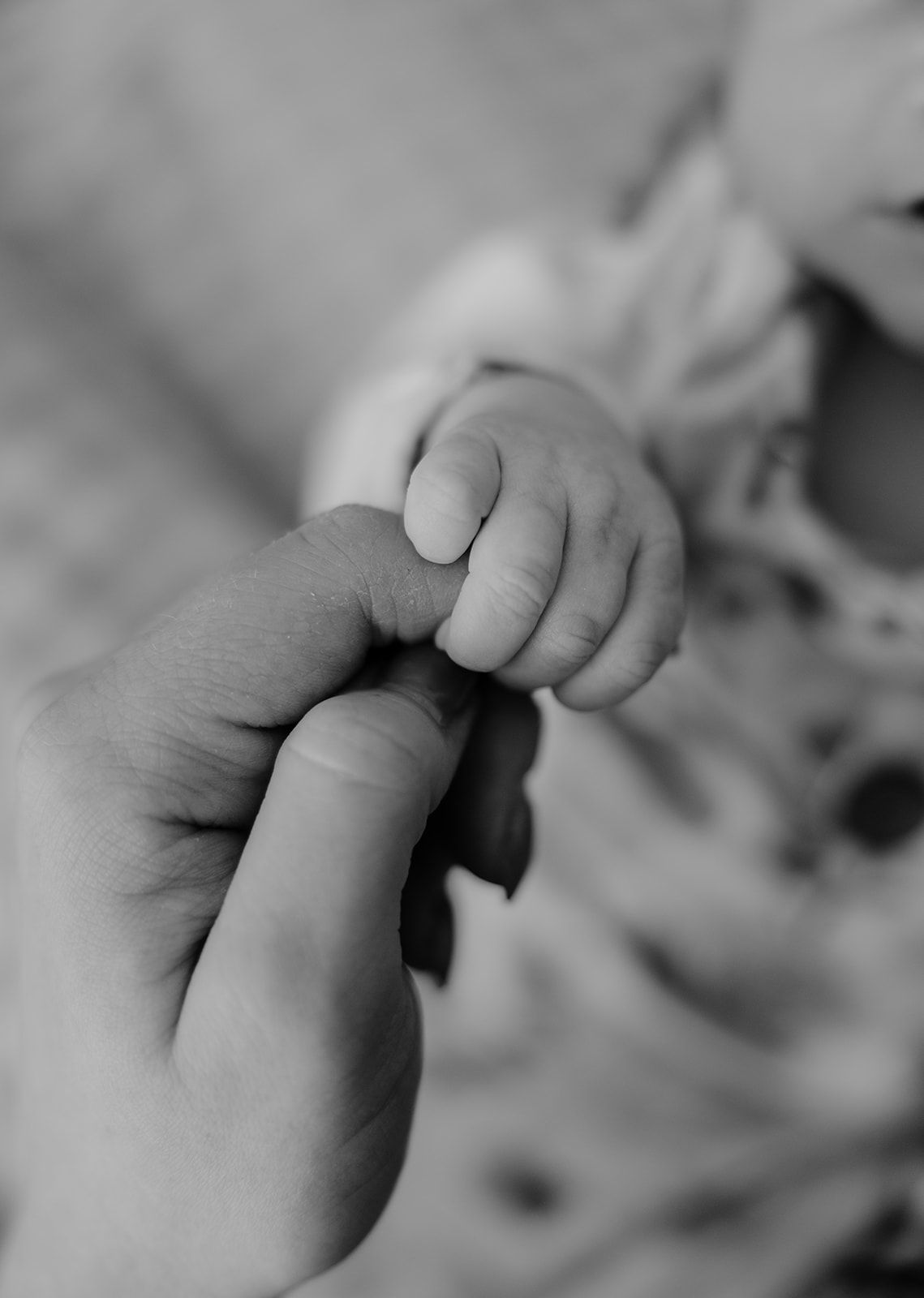 Newborn photos, baby holding mom's finger