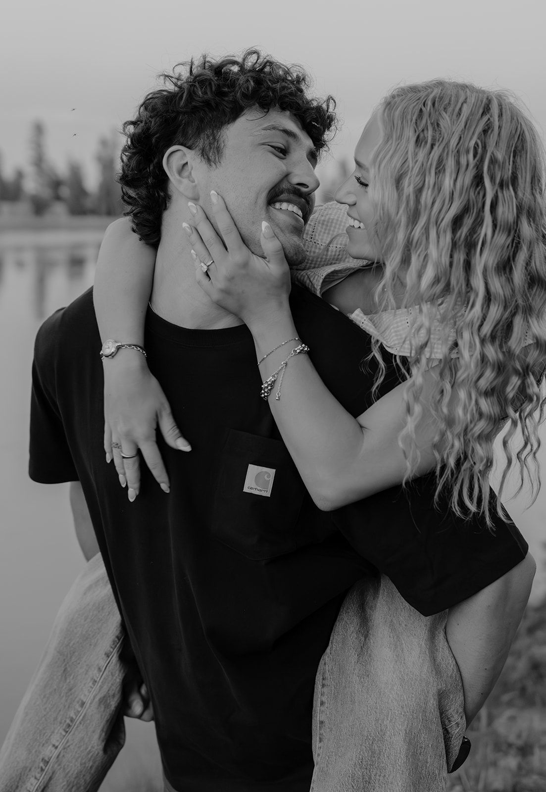 Black and white intimate photo during couples engagement session in Island Park, Idaho by the lake