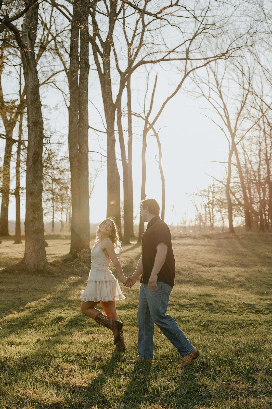 Photo of a couple walking in a grassy field