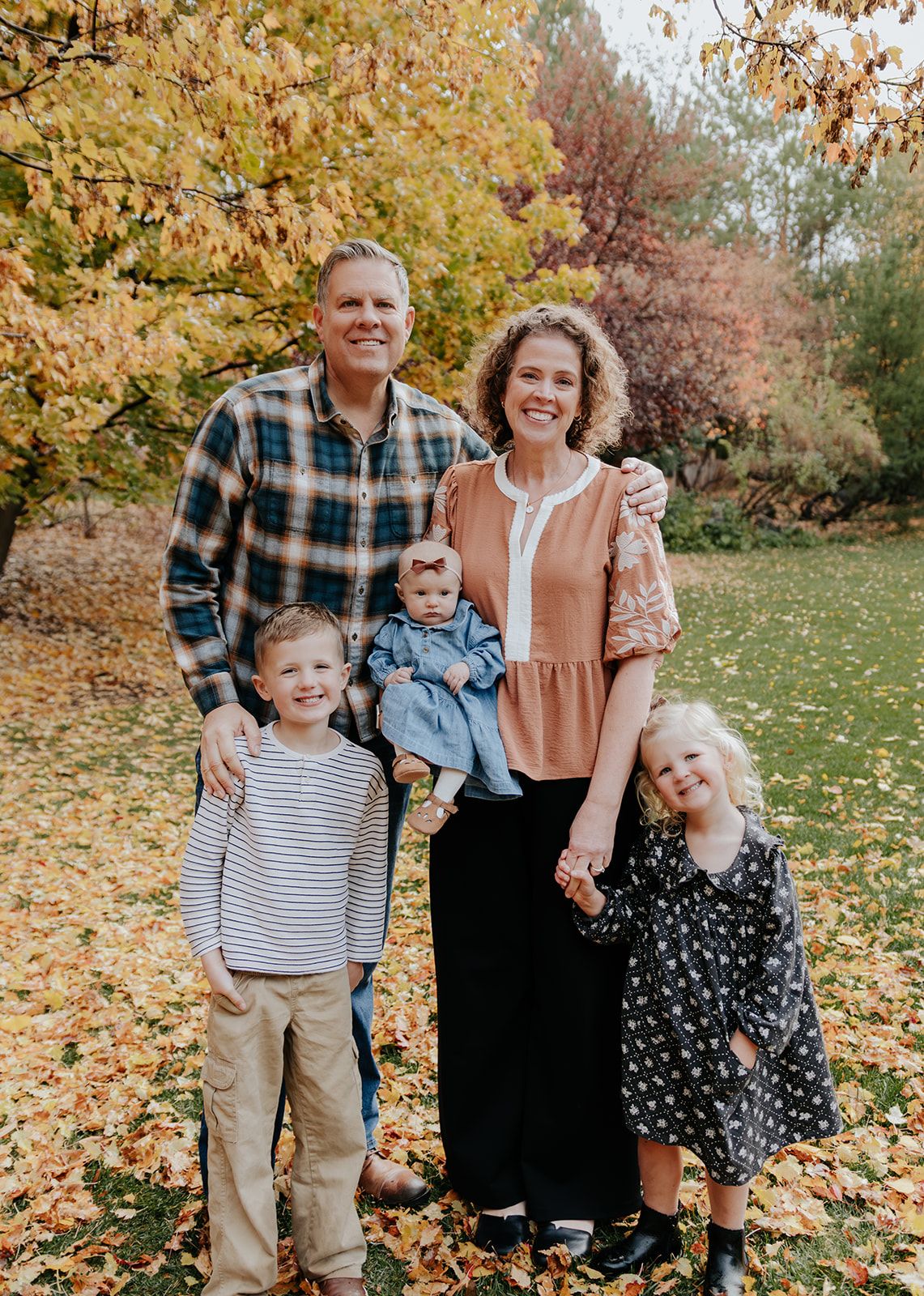 Grandparents with their grandchildren in Rexburg, Idaho during family photoshoot in the fall