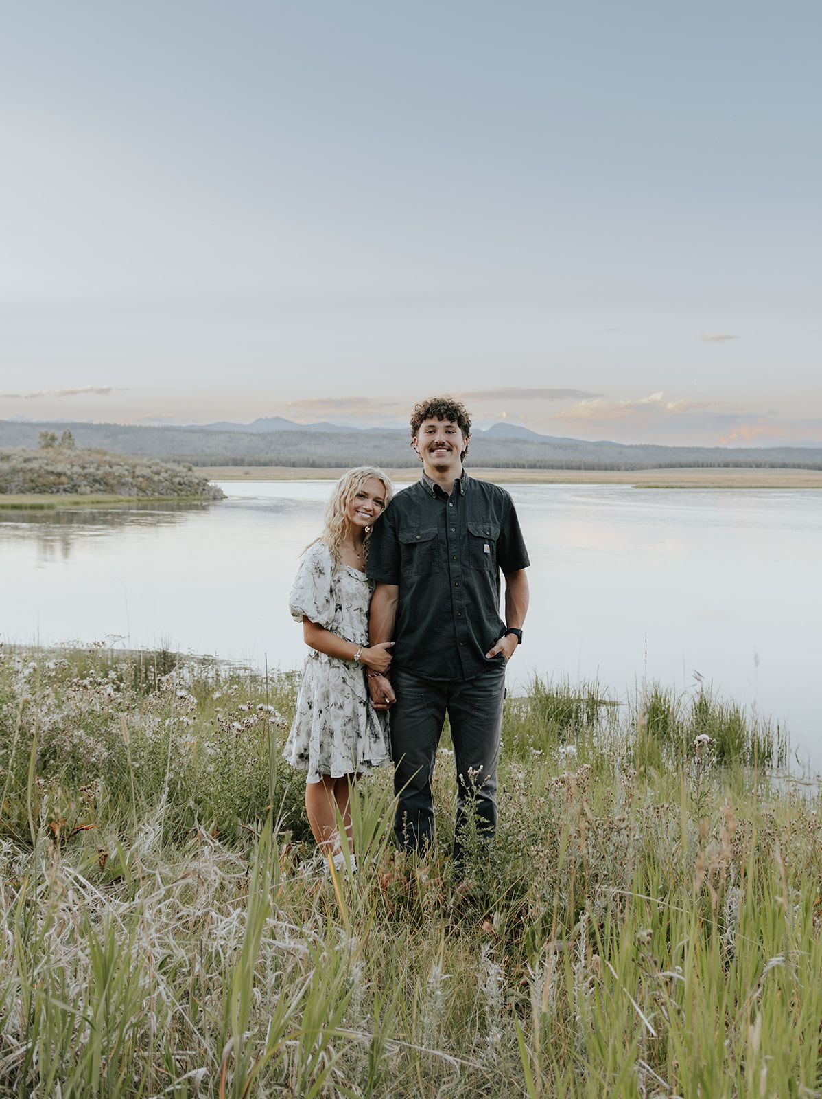 Couples engagement session at Harriman State Park in Island Park, Idaho by the lake in August at sunset. Wedding announcement photo
