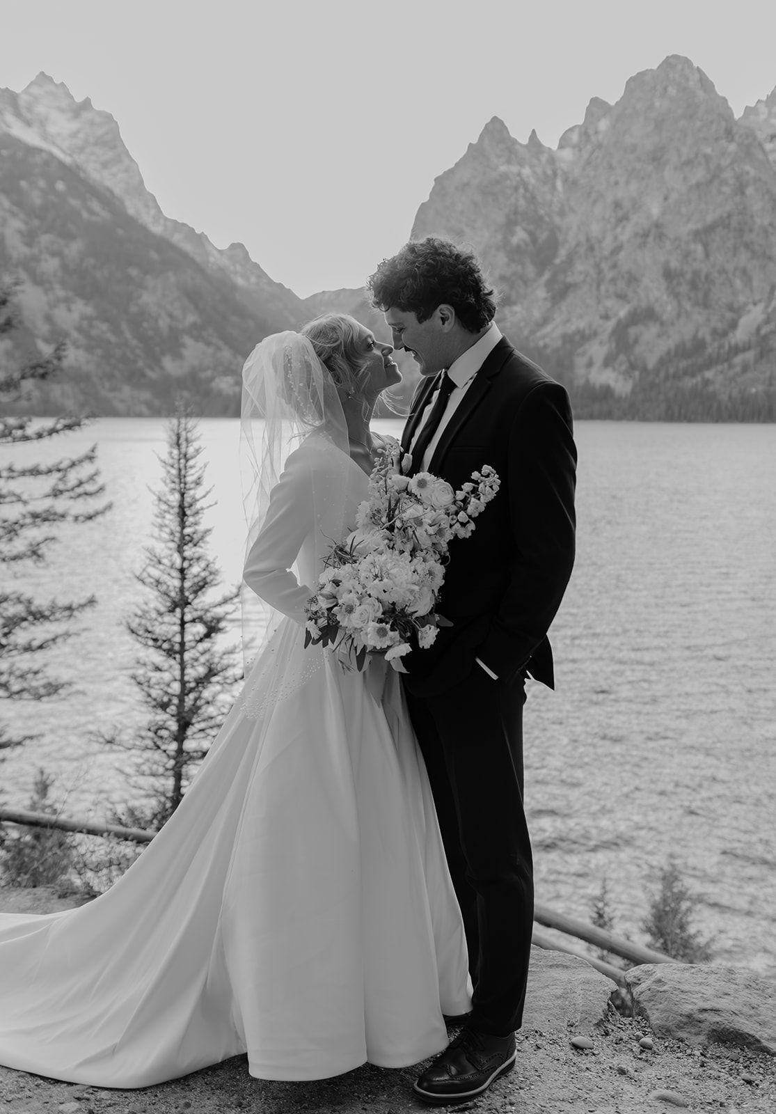 Photo of bride and groom at Jenny Lake in Grand Teton National Park at sunset. Bridal photos in the Tetons