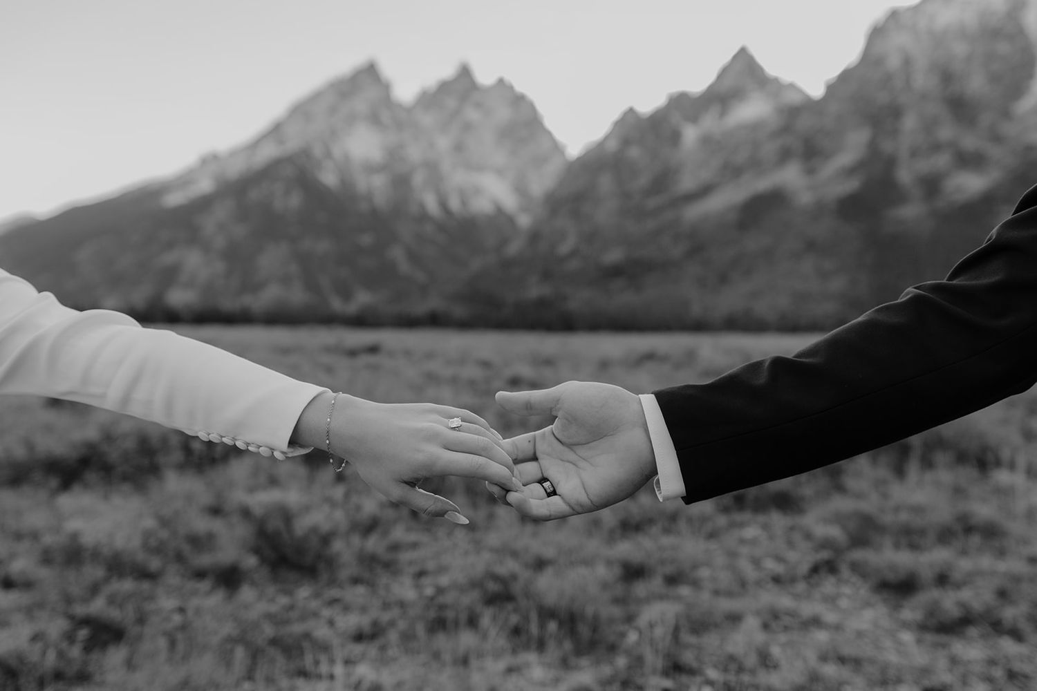 Black and white photo, holding hands in Grand Teton National Park