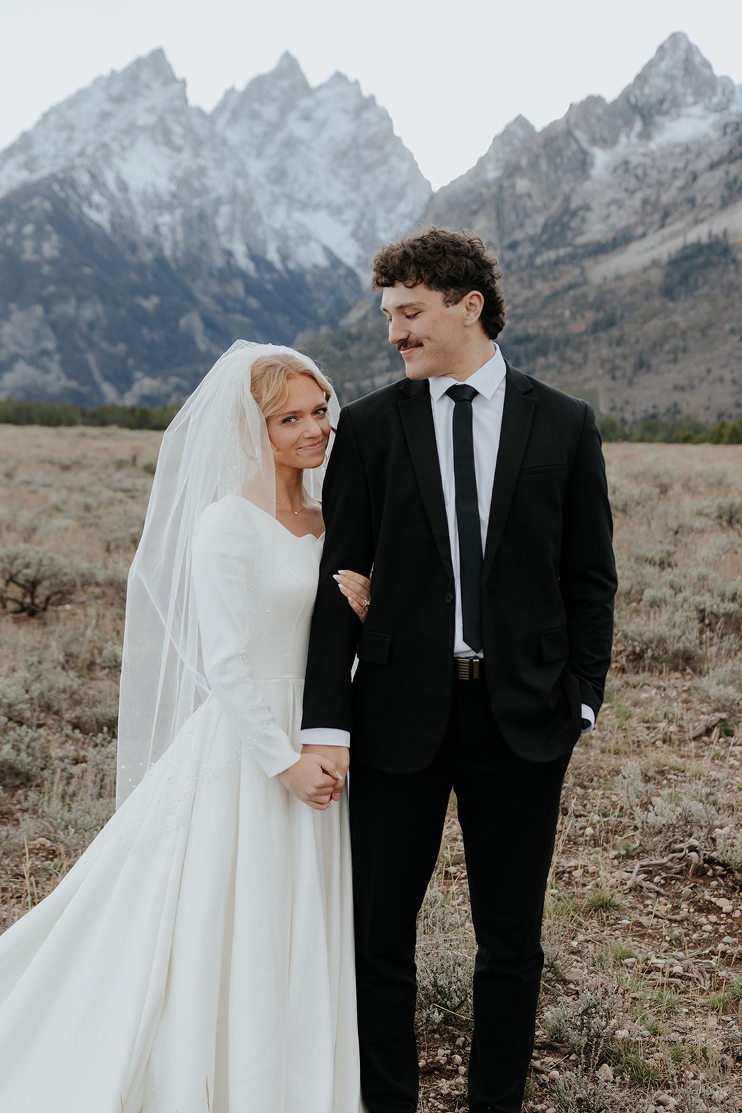 Groom looking at bride during bridal photos in Grand Teton National Park, bridal photos in Jackson Hole, Wyoming