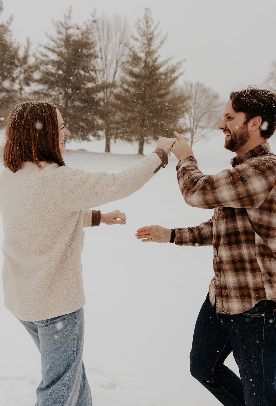 Snowy photoshoot of couple in Springfield, Missouri, candid engagement photos