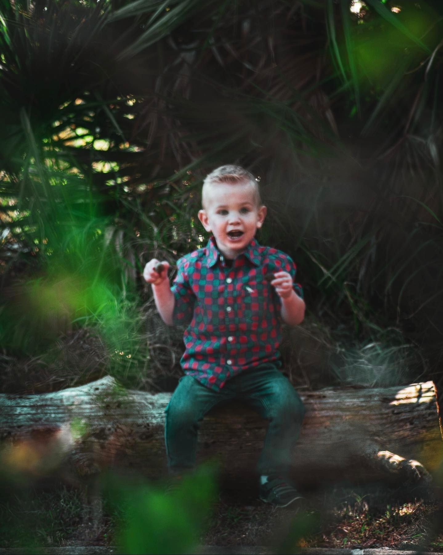 A joyful moment captured in a garden setting with greenery and natural lighting.