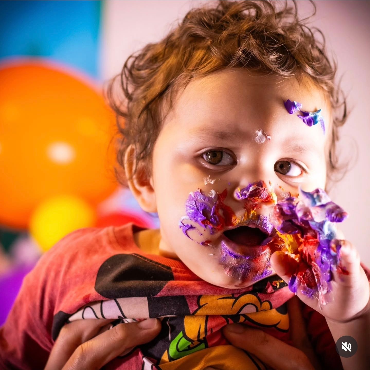 Close-up sequence of someone playfully blowing colorful confetti against an orange background.