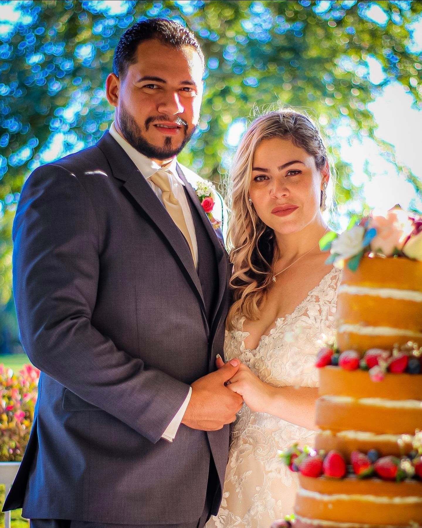 Wedding celebration photos featuring a multi-tiered cake with fresh berries in an outdoor setting.