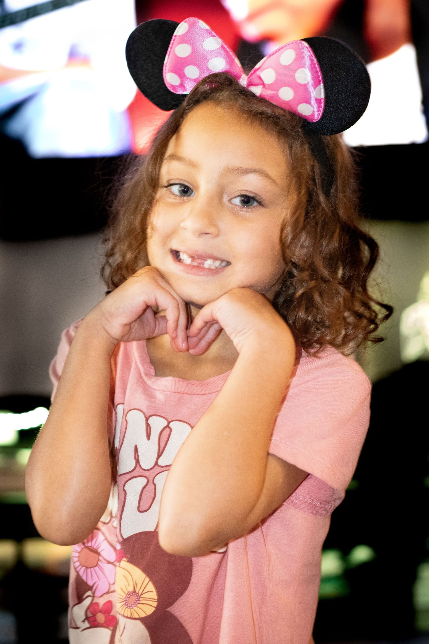 Playful scene with pink Minnie Mouse ears and joyful expressions.