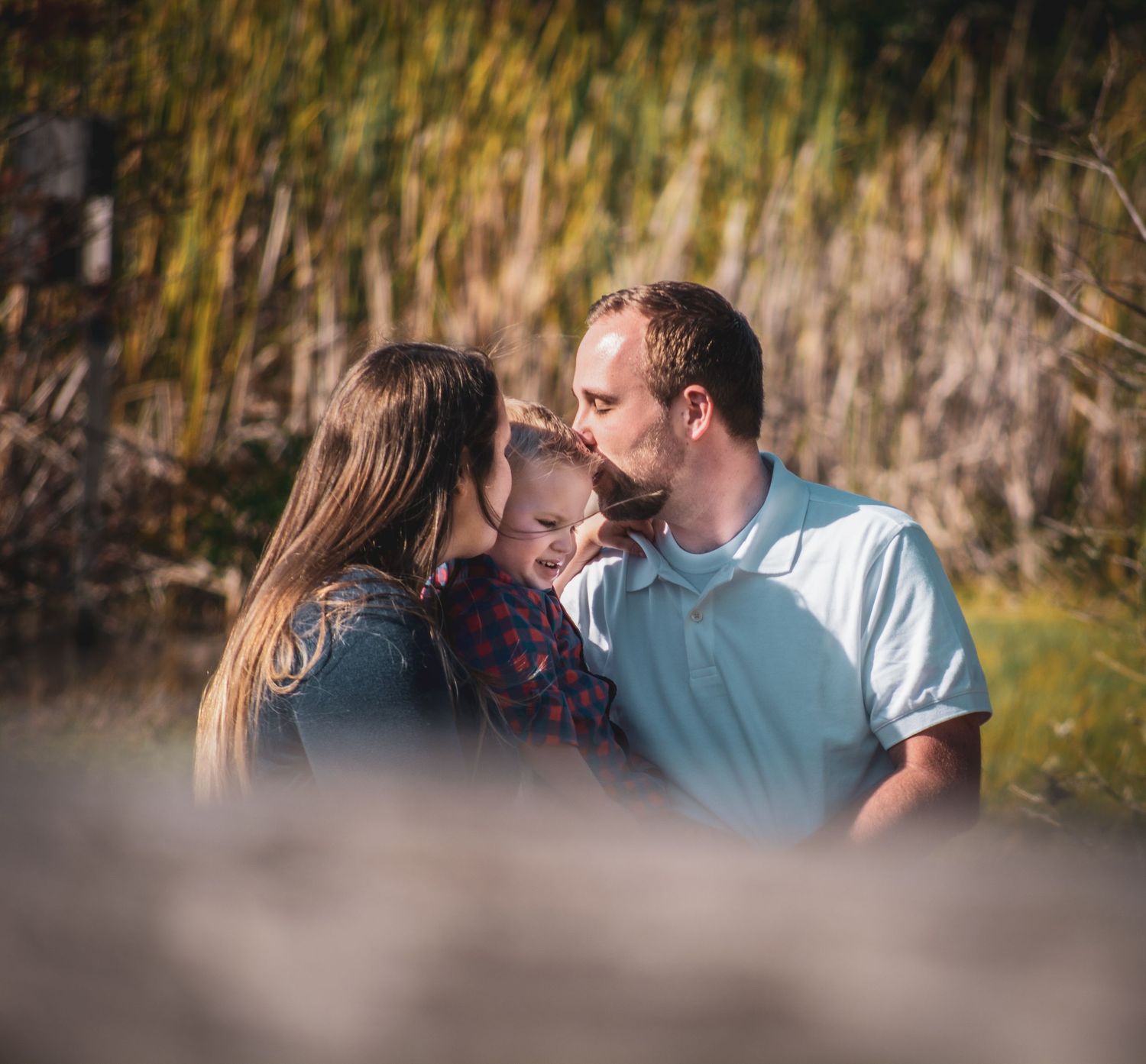 Romantic couple sharing intimate moment in natural outdoor setting.