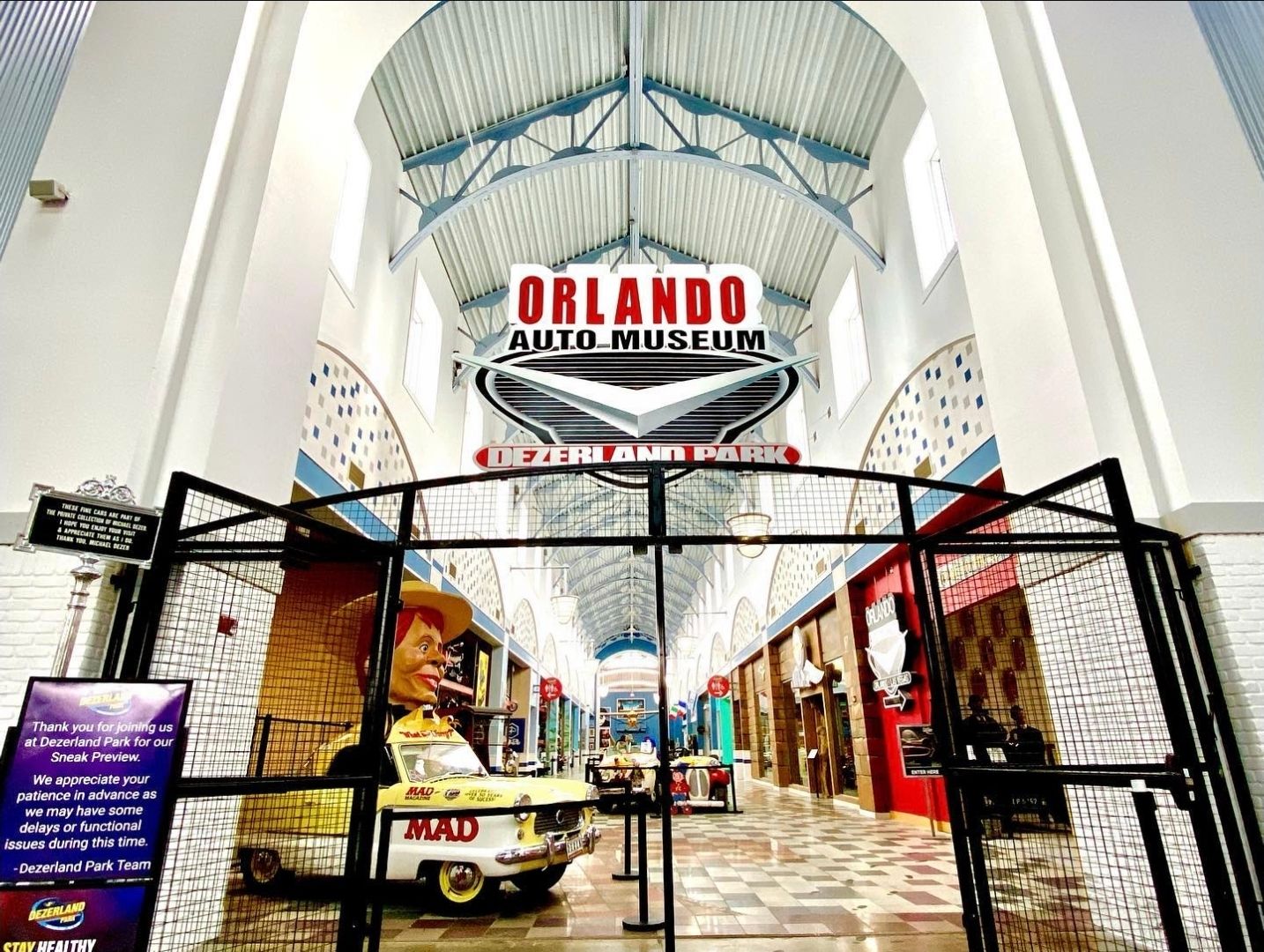 Orlando arcade entrance with black metal gates and white architectural details.