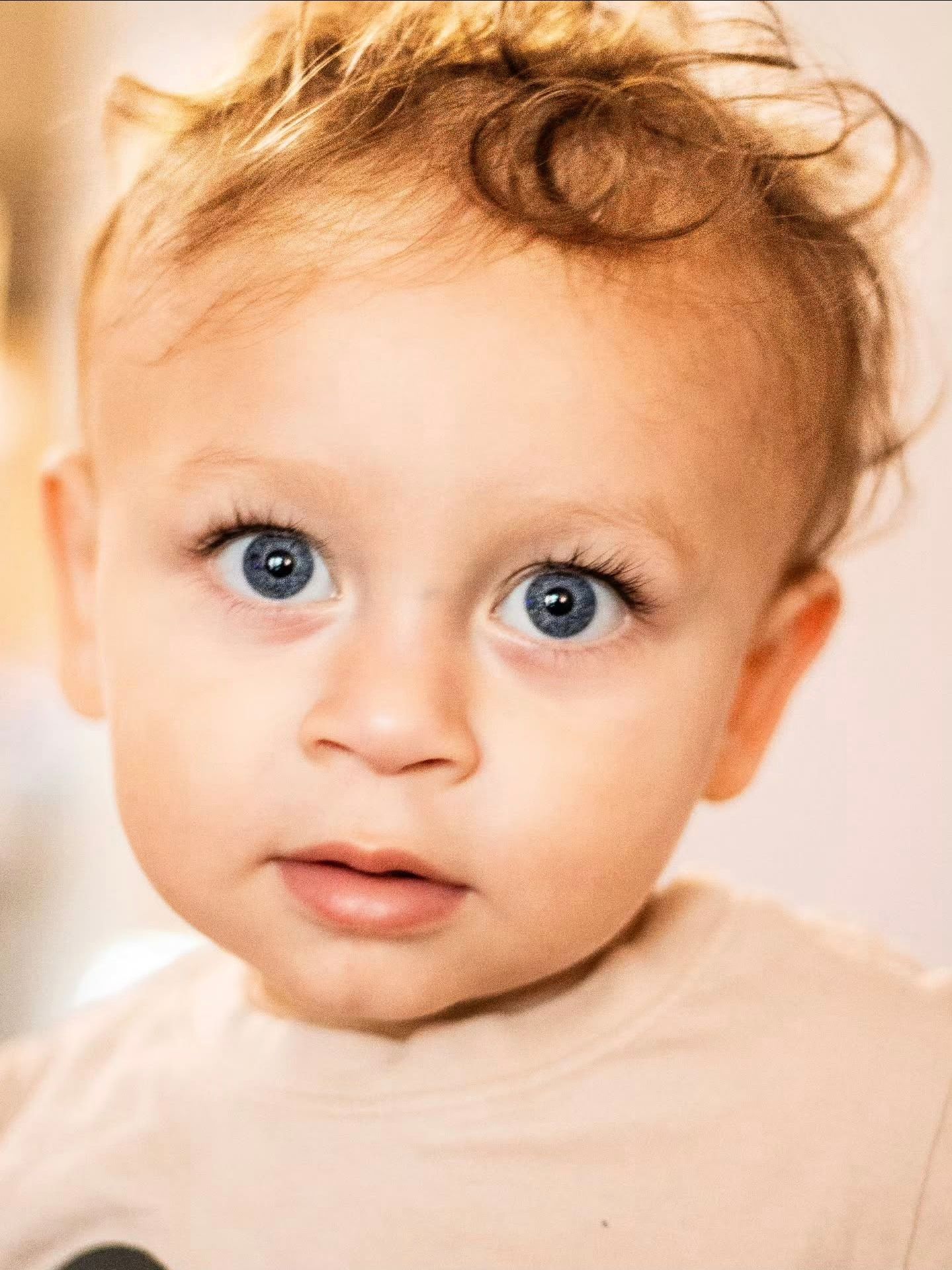 Close-up portrait showcasing bright blue eyes and gentle expression.