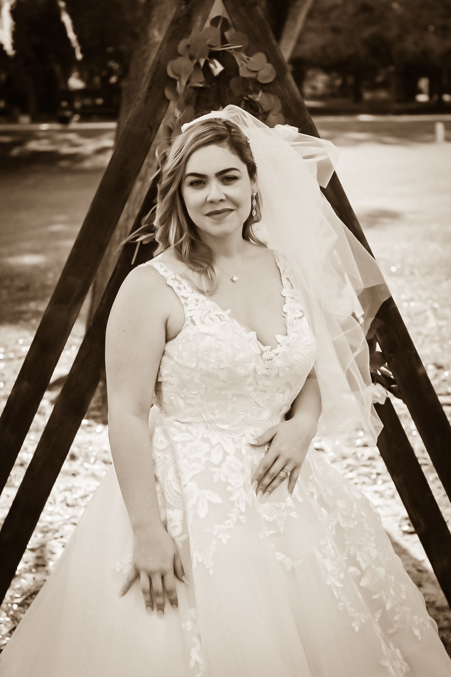 Sepia-toned sequence showing details of an elegant lace wedding dress.