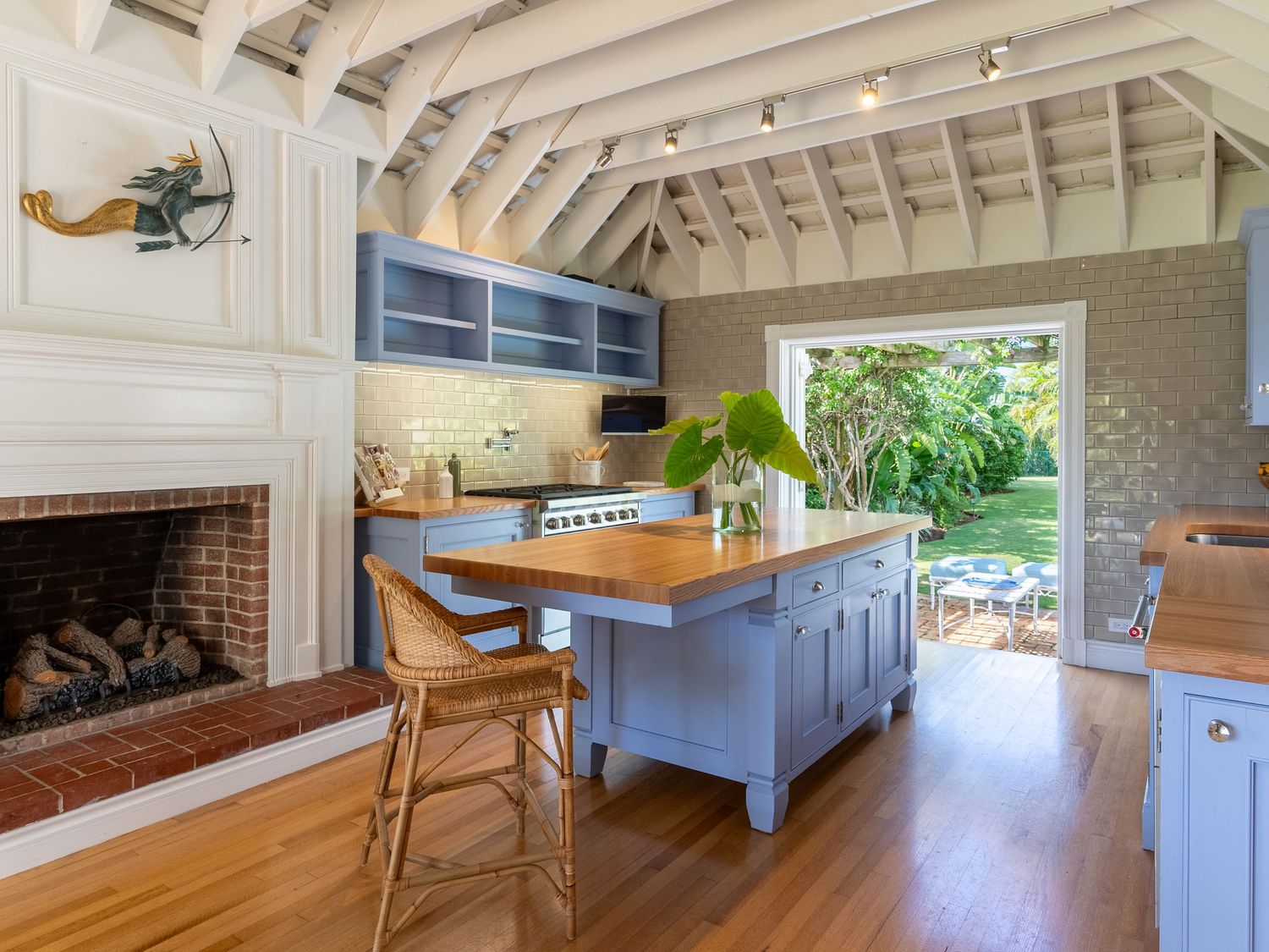 Modern coastal home interior featuring custom built-in cabinetry and vaulted ceilings with exposed beams.