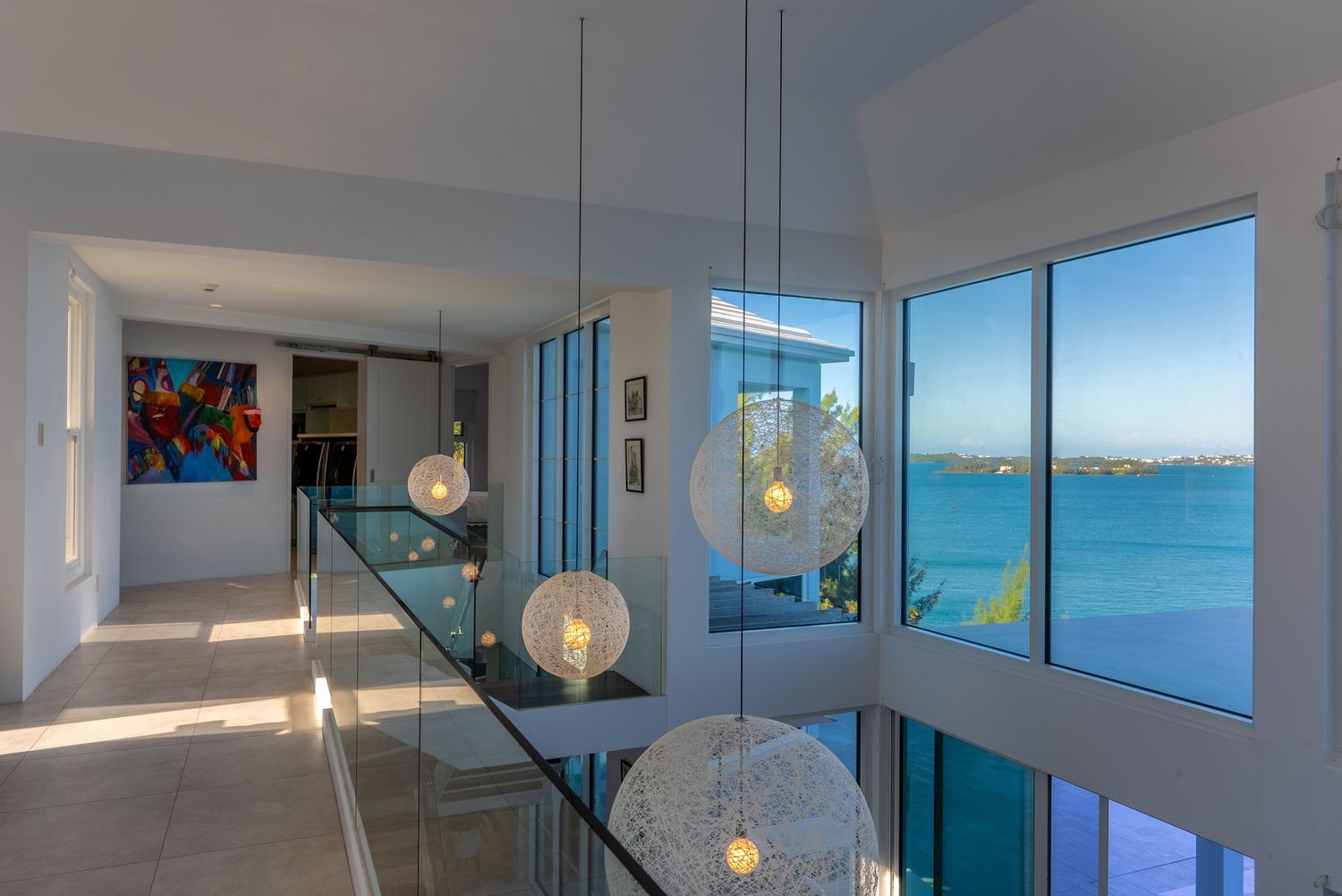 Modern coastal living room with floor-to-ceiling windows overlooking ocean views.