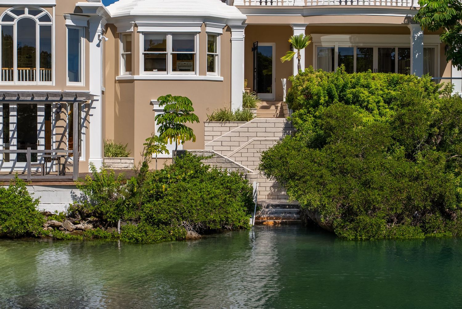 Waterfront luxury homes with private docks extending into calm turquoise waters.