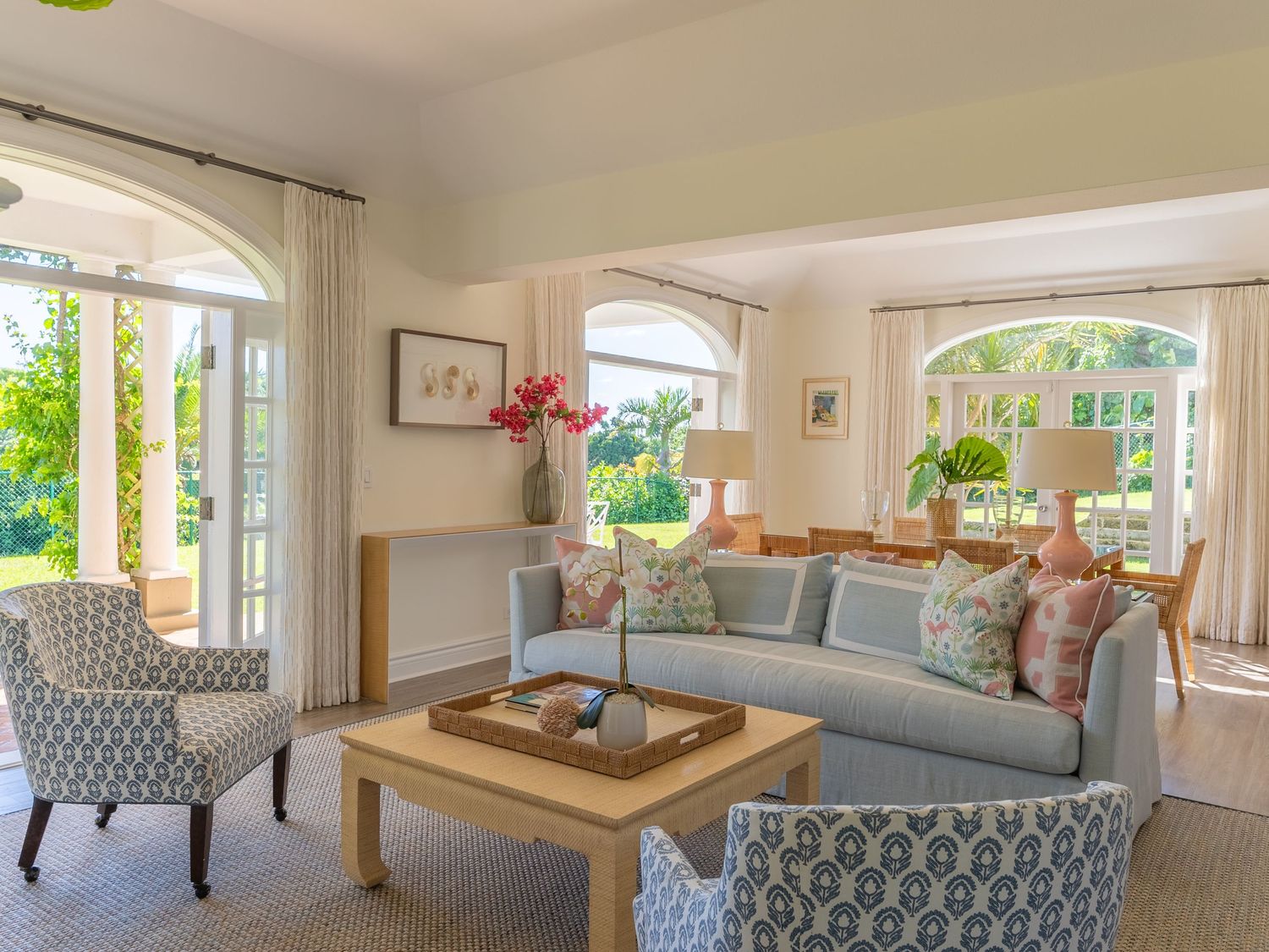 Elegant living room with coastal views, comfortable seating, and natural light streaming through large windows.