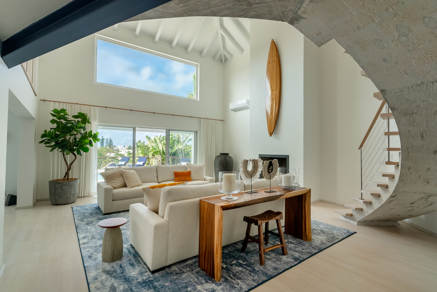 Contemporary white interior featuring spiral staircase and floor-to-ceiling windows.