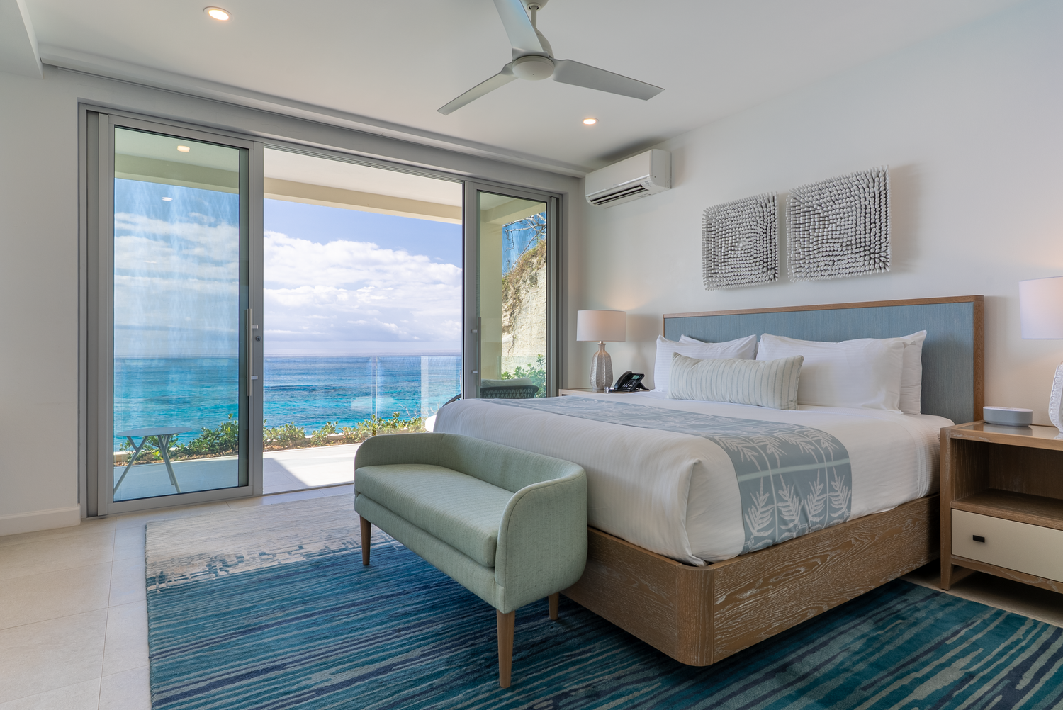 Modern beachfront hotel rooms with panoramic ocean views and contemporary furnishings.