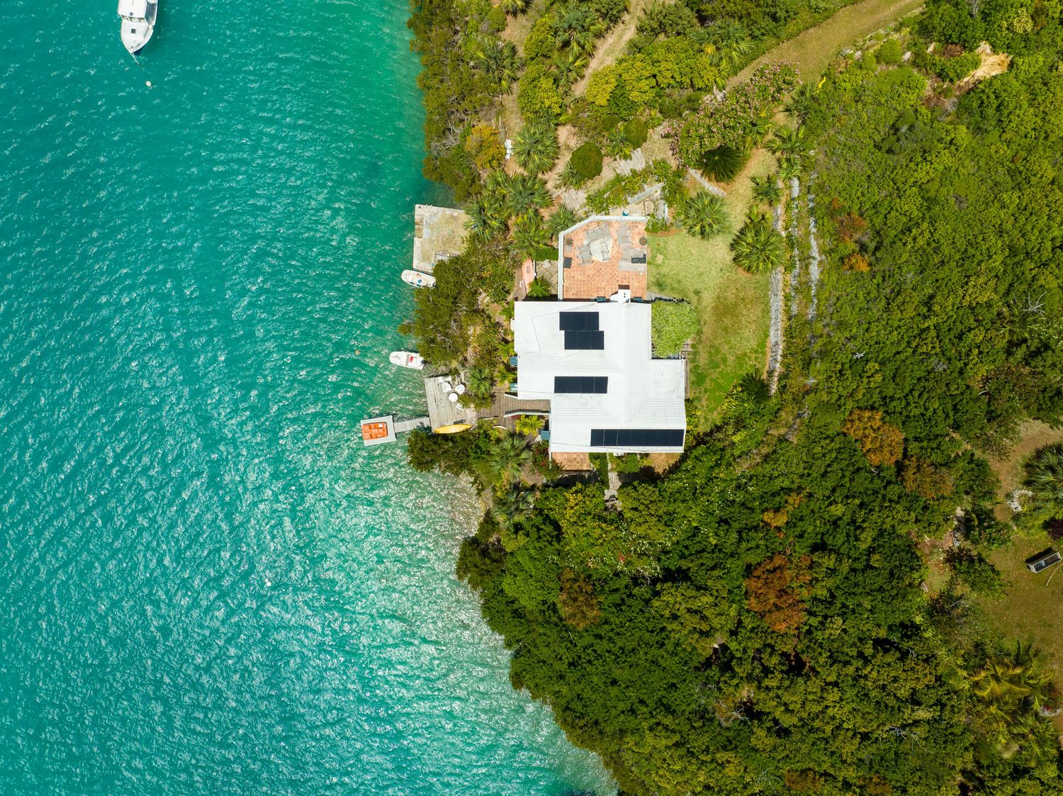 Drone shot of coastal properties with private docks surrounded by crystal clear turquoise waters. Drone photogrpahy.