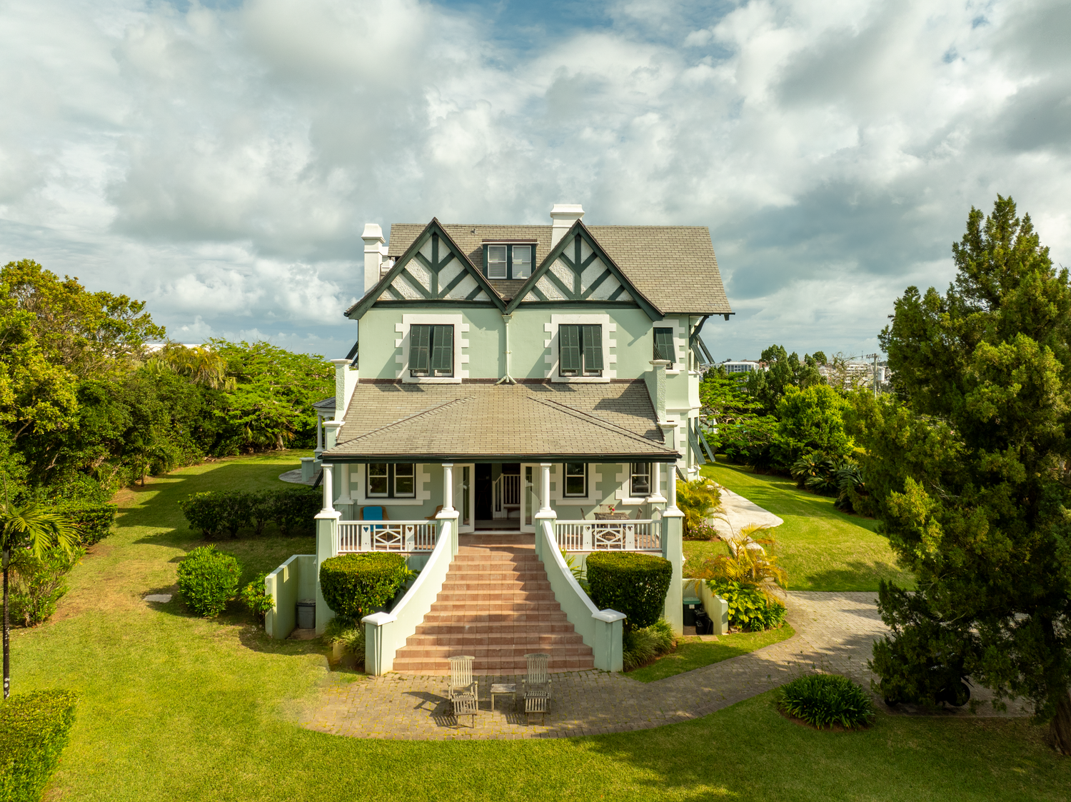 Panoramic view of coastal homes with traditional architecture set against cloudy skies. Drone photogrpahy.