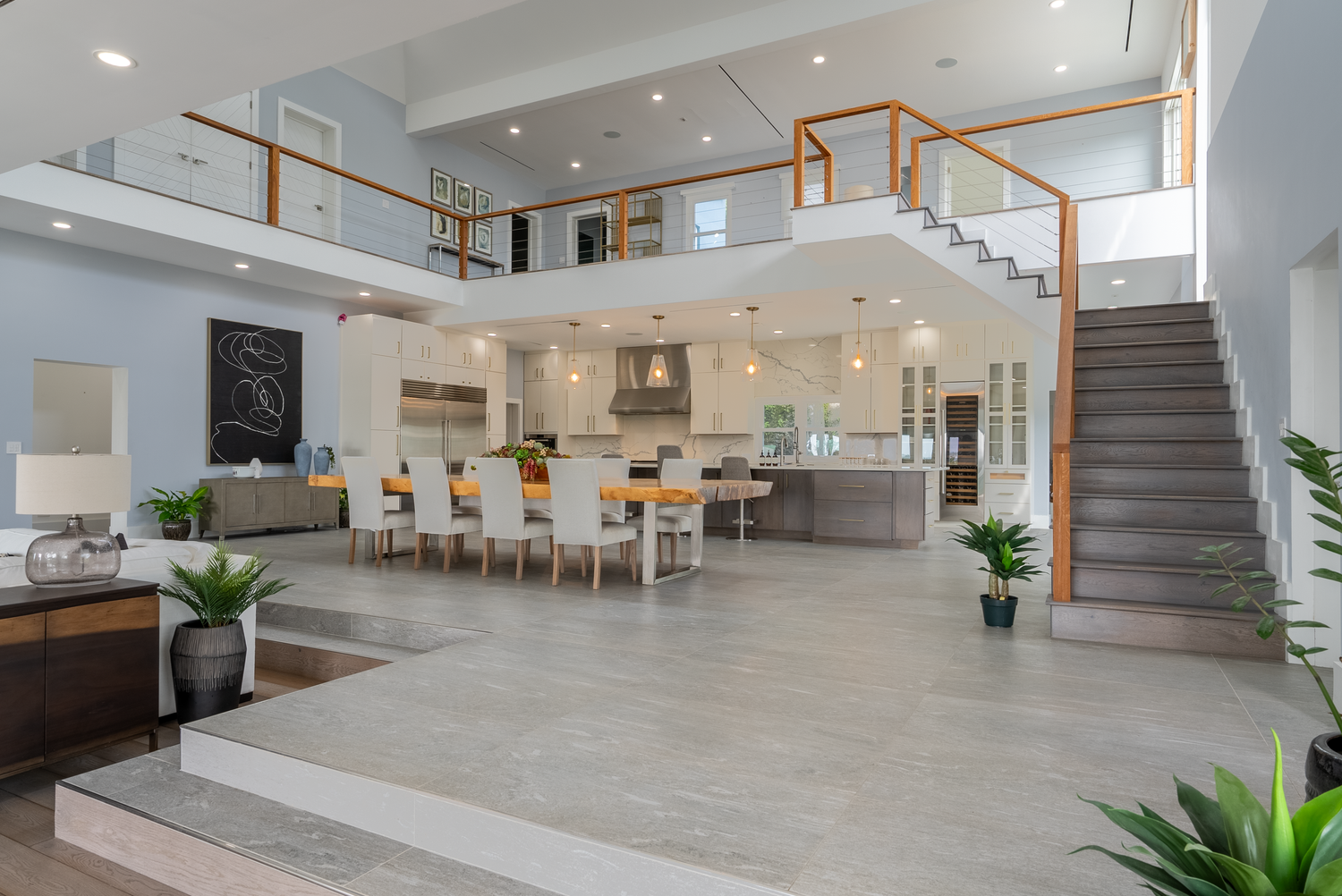 Spacious open-concept living area with modern finishes and natural light flooding through windows.