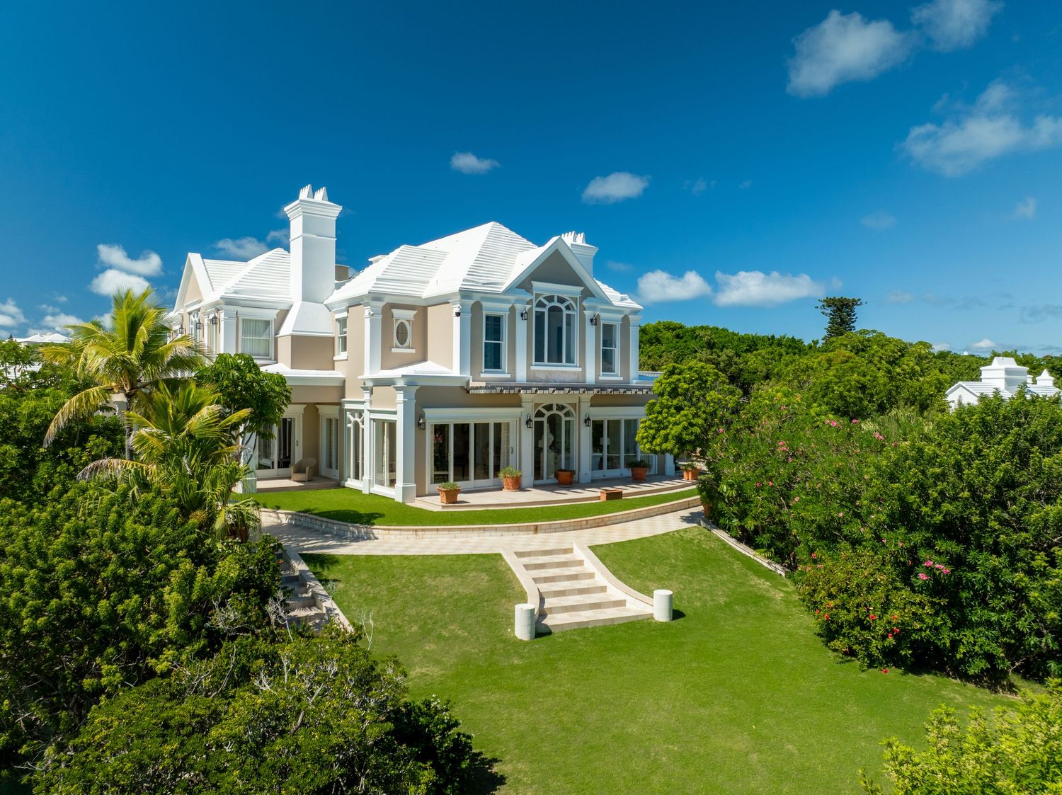 Panoramic view of a luxury beachfront estate with pristine landscaping and ocean vistas. Drone photogrpahy.