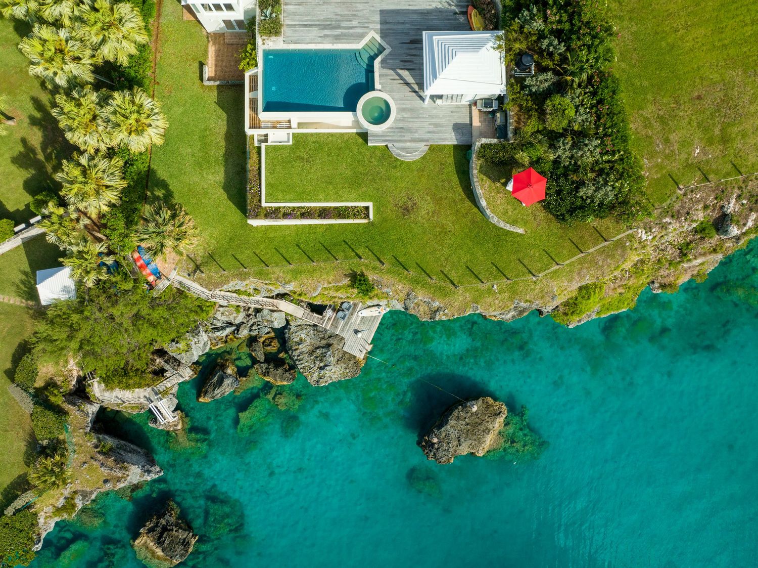 Aerial view of luxury waterfront properties with pristine turquoise waters and landscaped gardens. Drone photogrpahy.