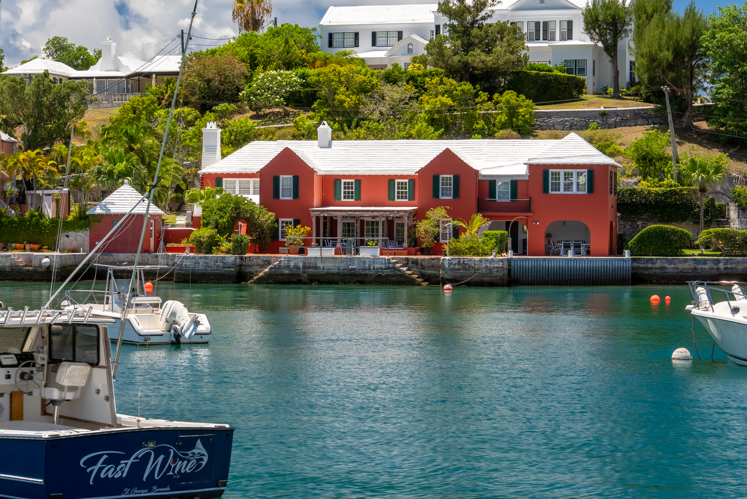 Scenic waterfront properties with colorful facades and boats docked along the shoreline.