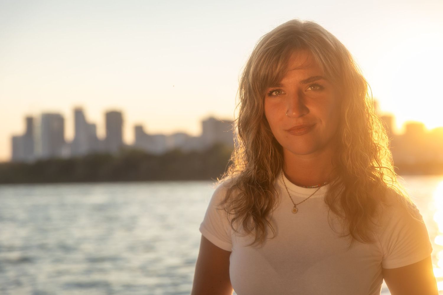 Sunset portrait with golden lighting near waterfront.