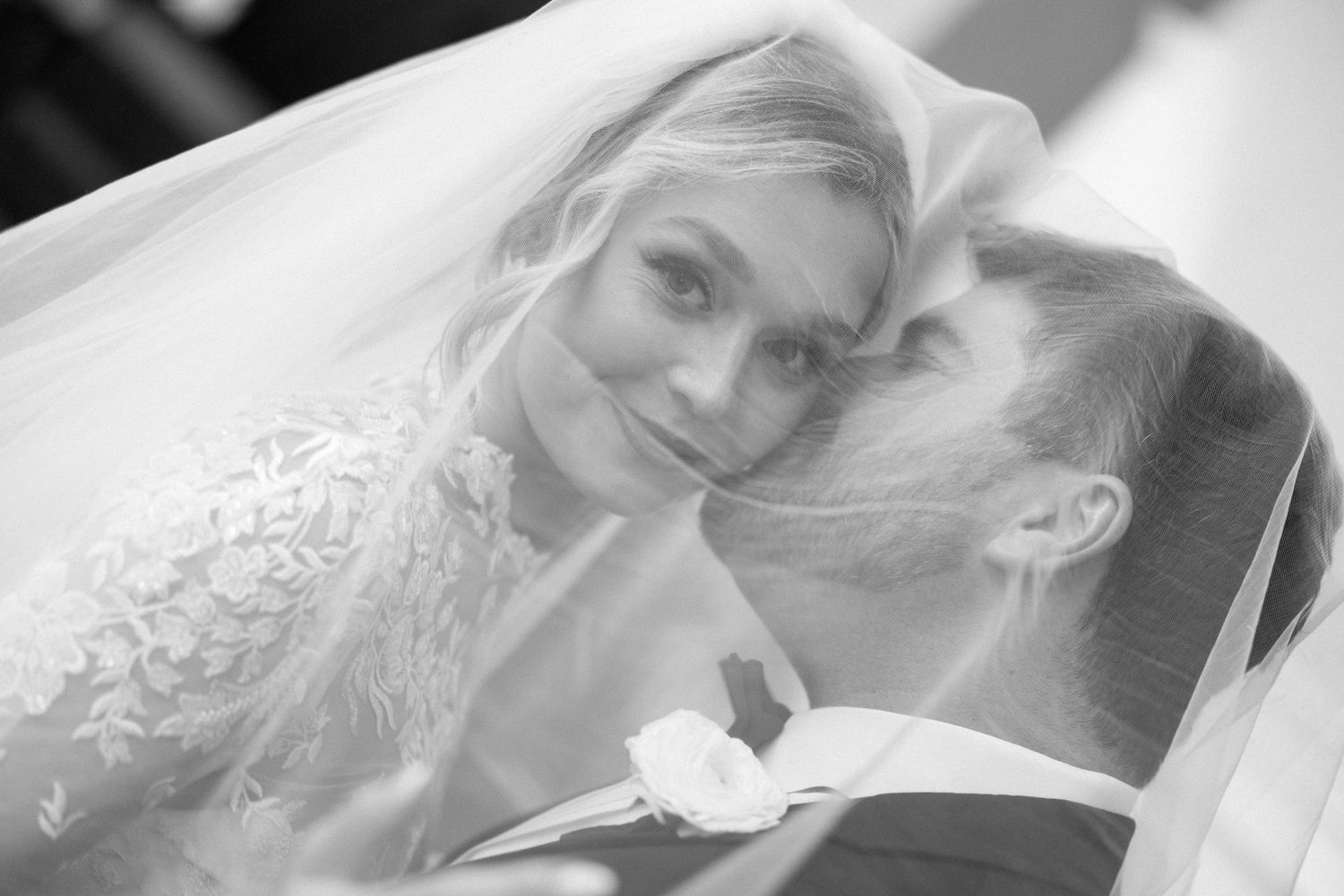 Dreamy close-up wedding portraits captured through delicate bridal veil.