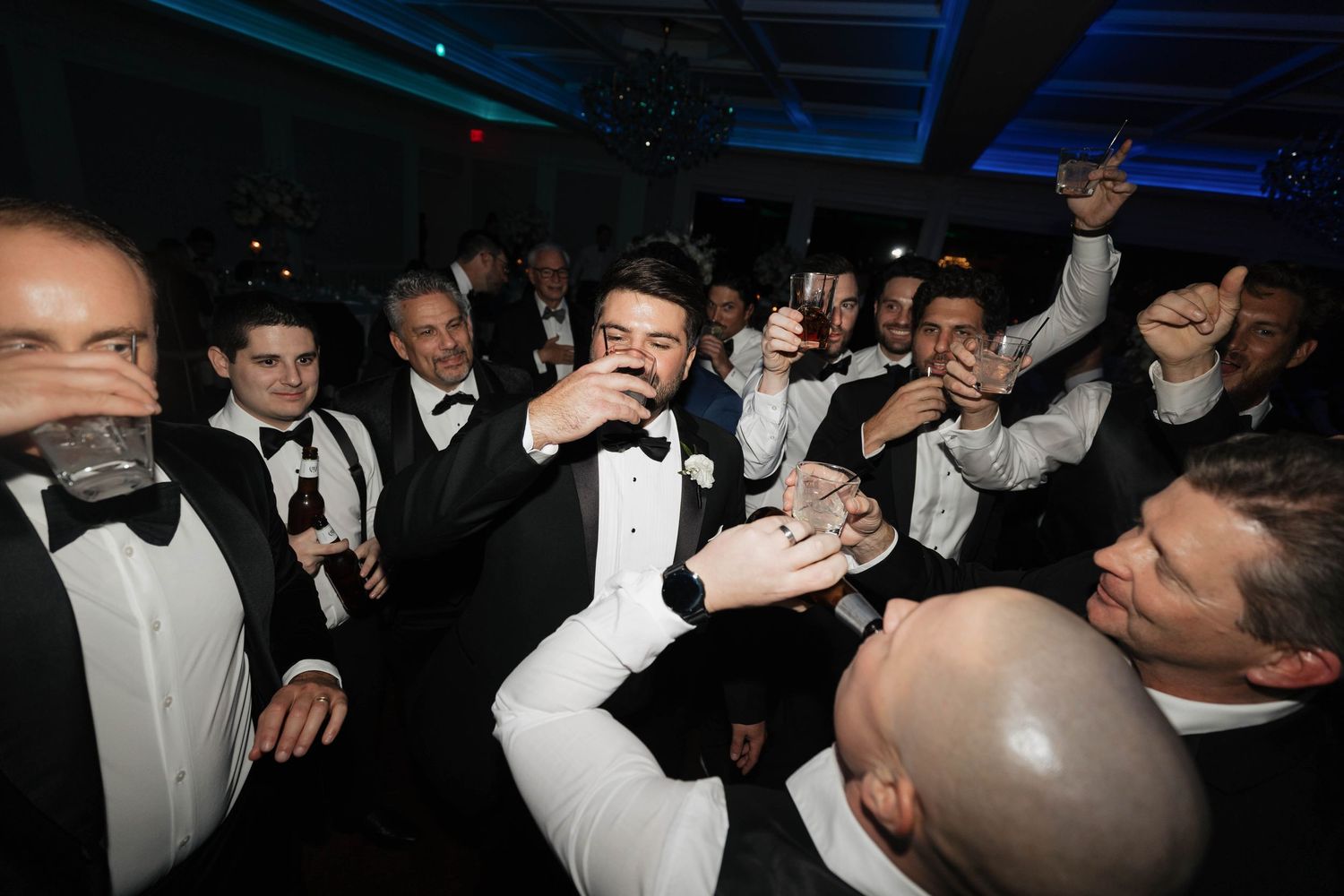 Lively dance floor scene at formal celebration with guests in evening wear.