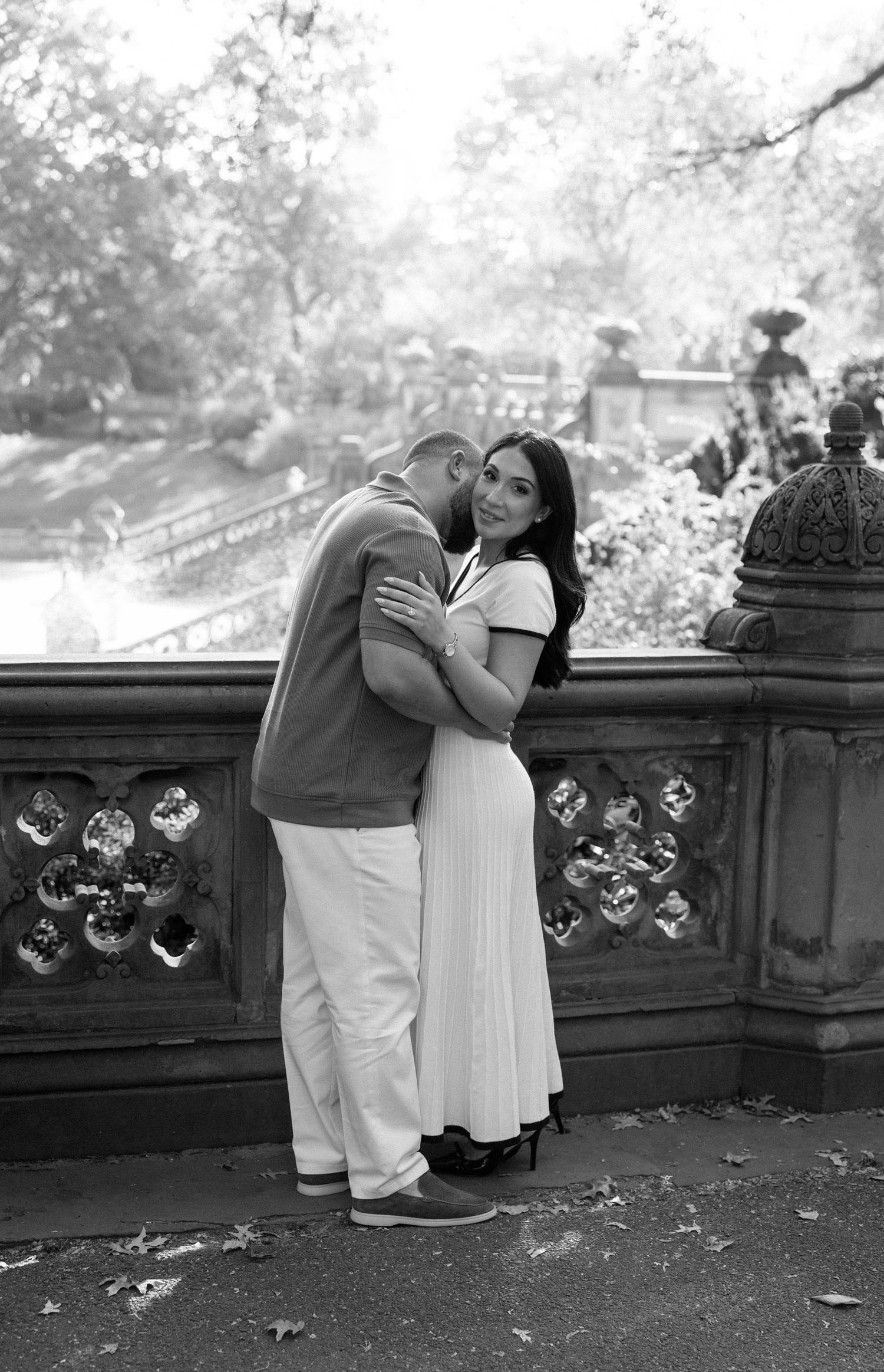 Romantic black and white sequence of a couple sharing intimate moments on a stone balcony.