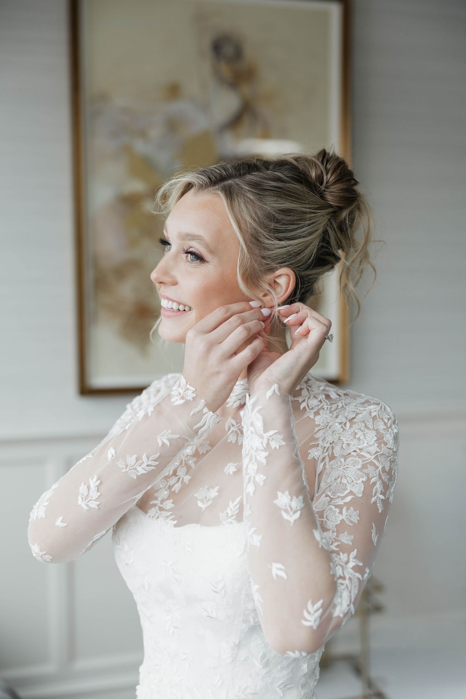 Close-up view of delicate lace long sleeve wedding dress details.