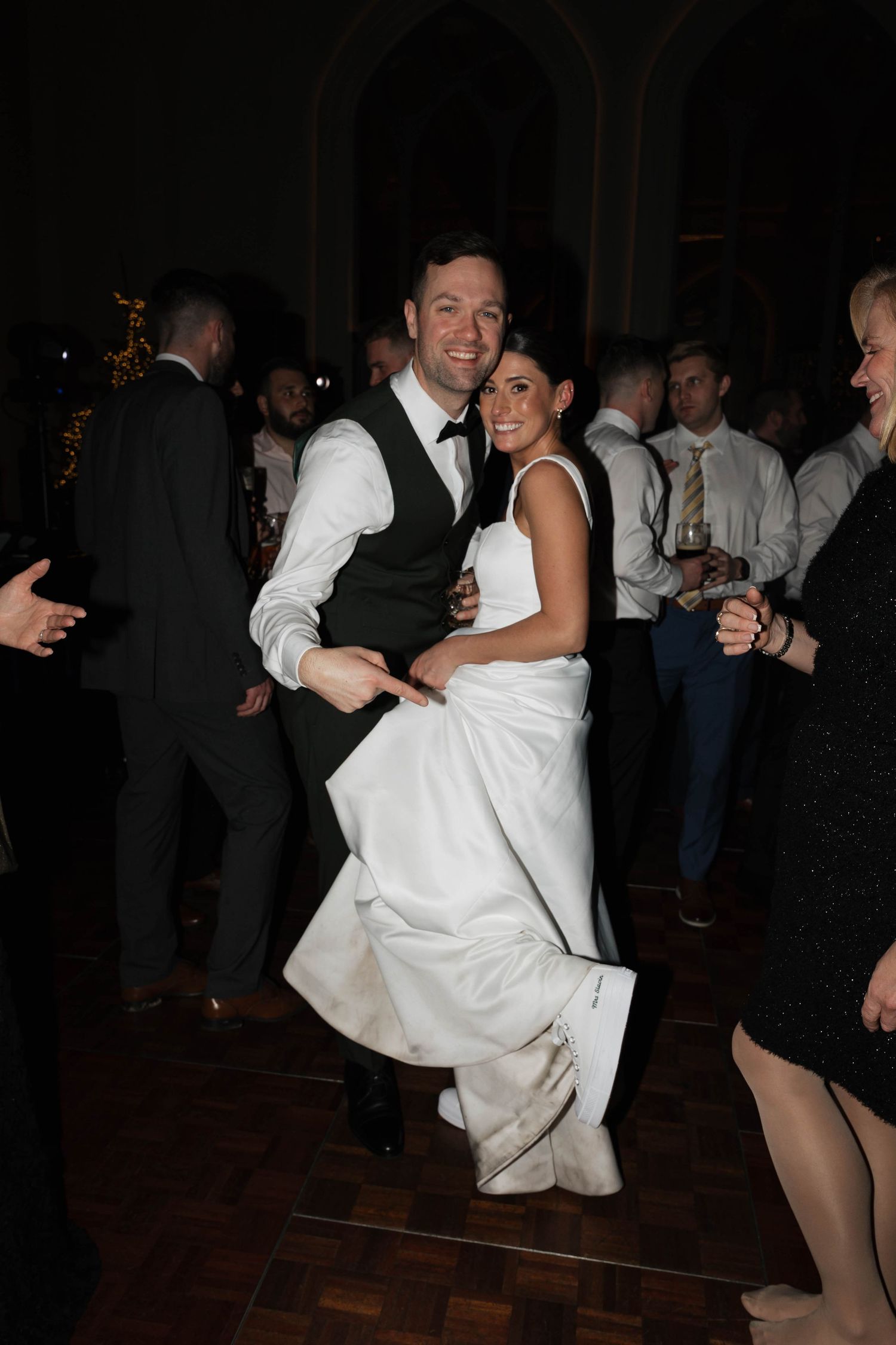 Wedding reception dance floor with guests celebrating in formal attire.