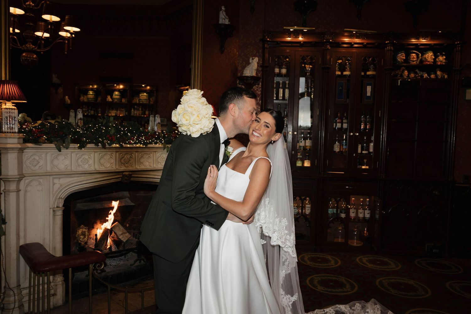 Romantic dance in cozy venue with fireplace and warm lighting.