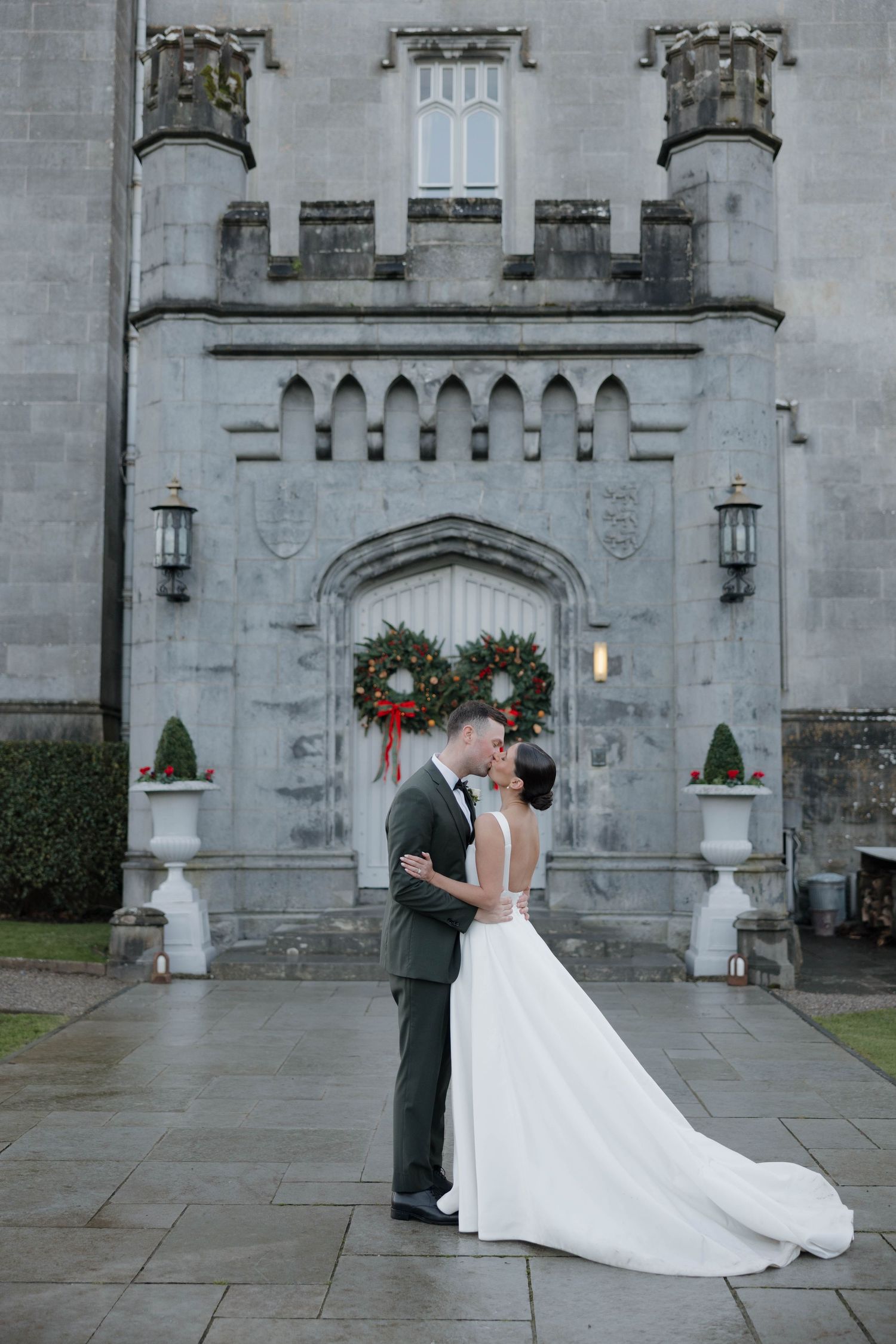 A romantic wedding portrait series against the backdrop of a grand stone castle.