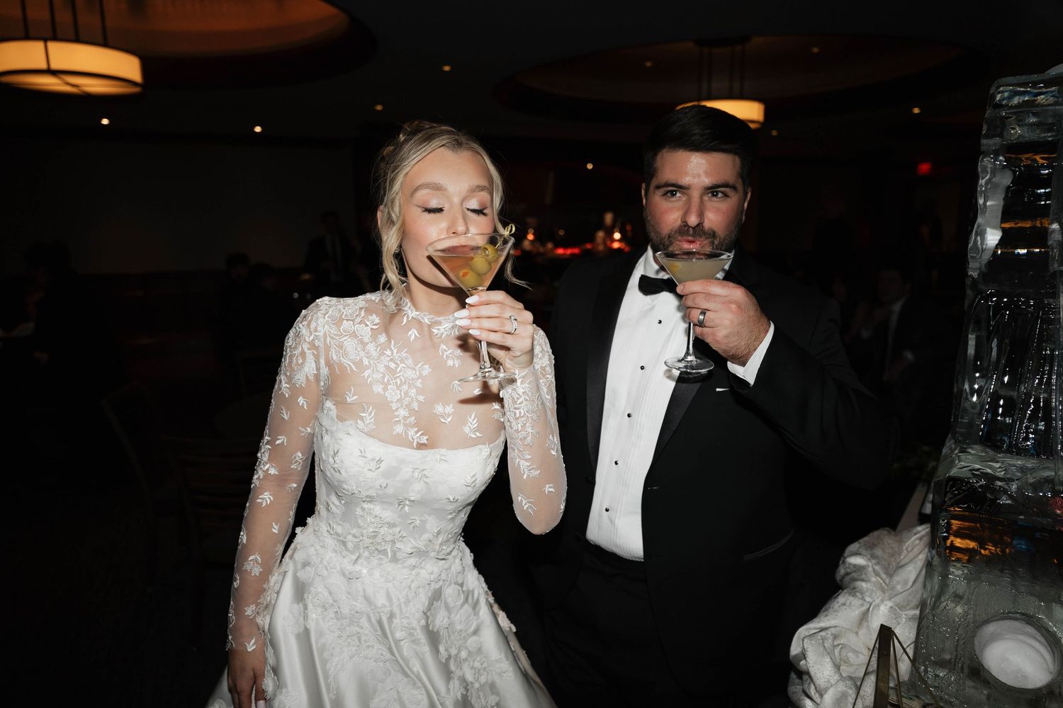 Evening wedding reception with formal attire and elegant table settings.