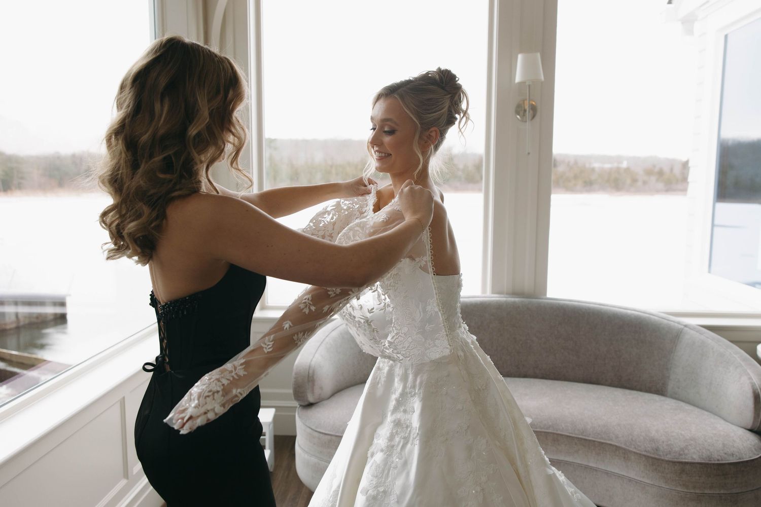 Intimate getting ready moment captured in natural window light.
