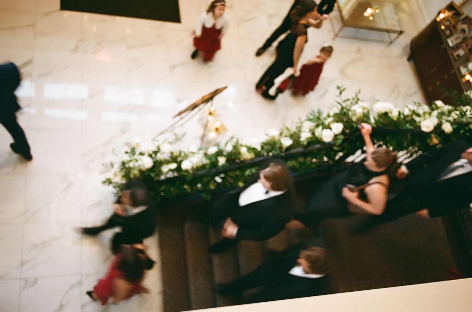 Dancers in motion perform on a hardwood floor during a contemporary dance performance.