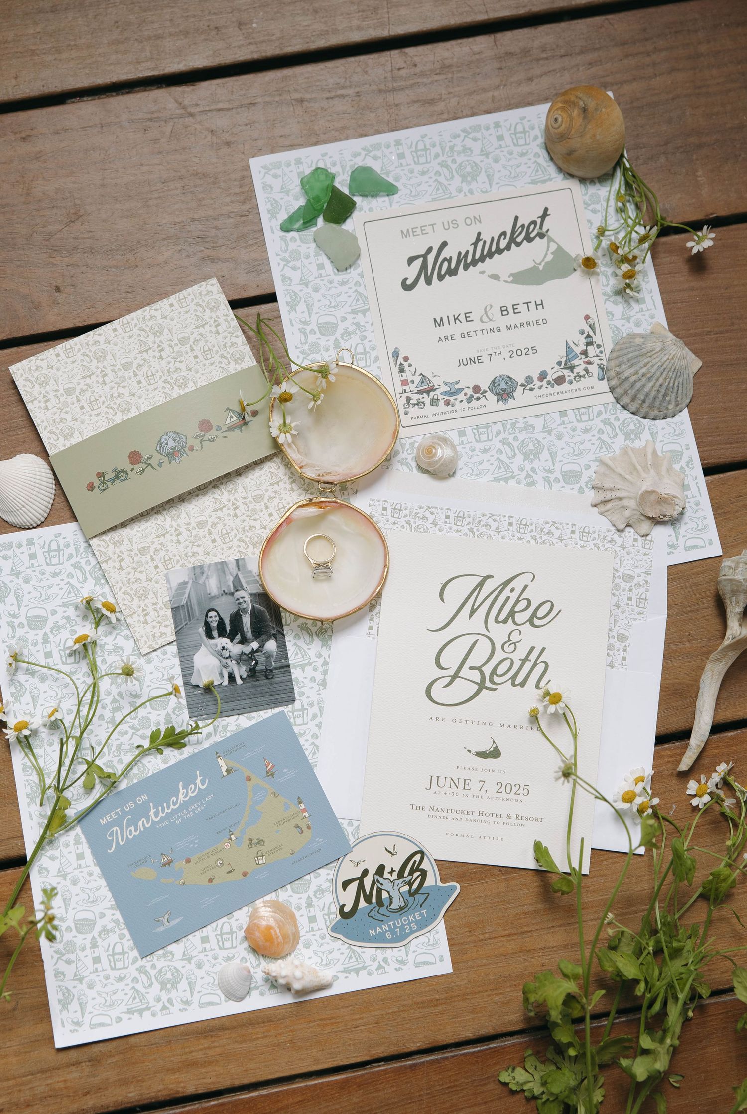 Elegant wedding stationery featuring Nantucket map and seashell decorations on wooden surface.