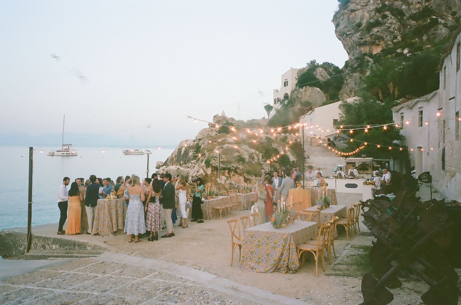 A series of vintage film photographs showing a beach scene with people and boats along a coastal shoreline.