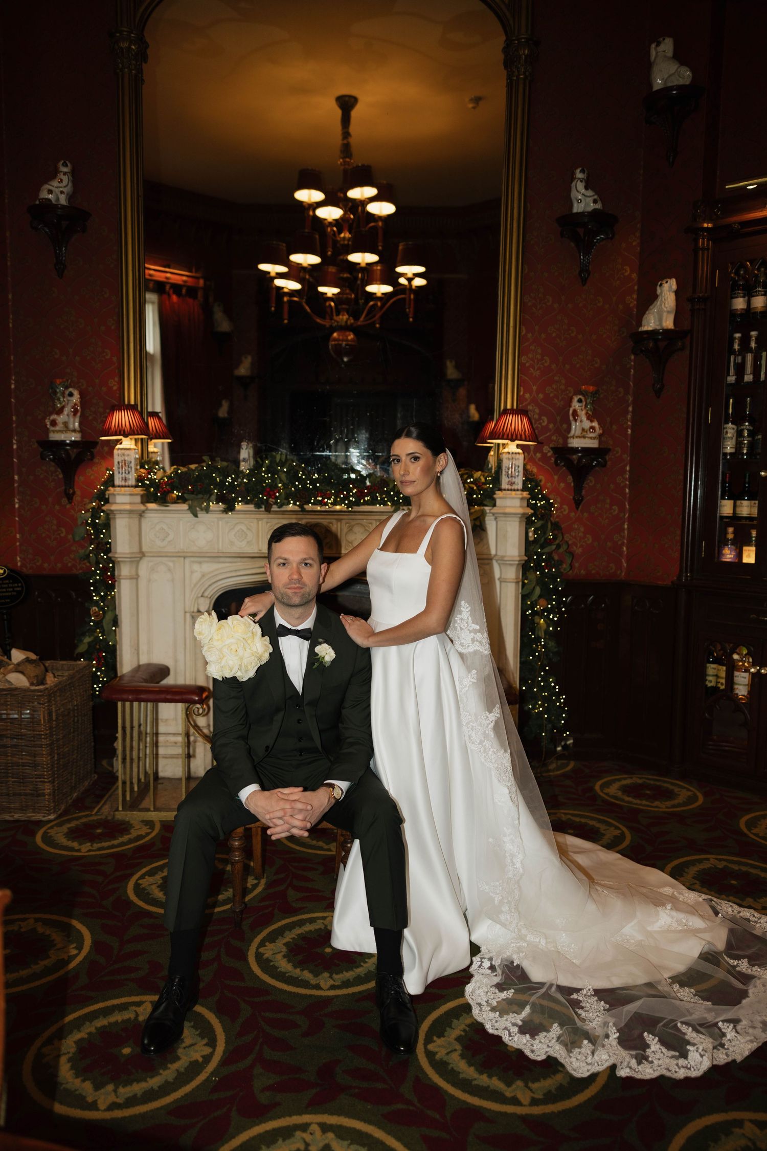 An intimate moment captured in a cozy bar setting with ornate carpet patterns.