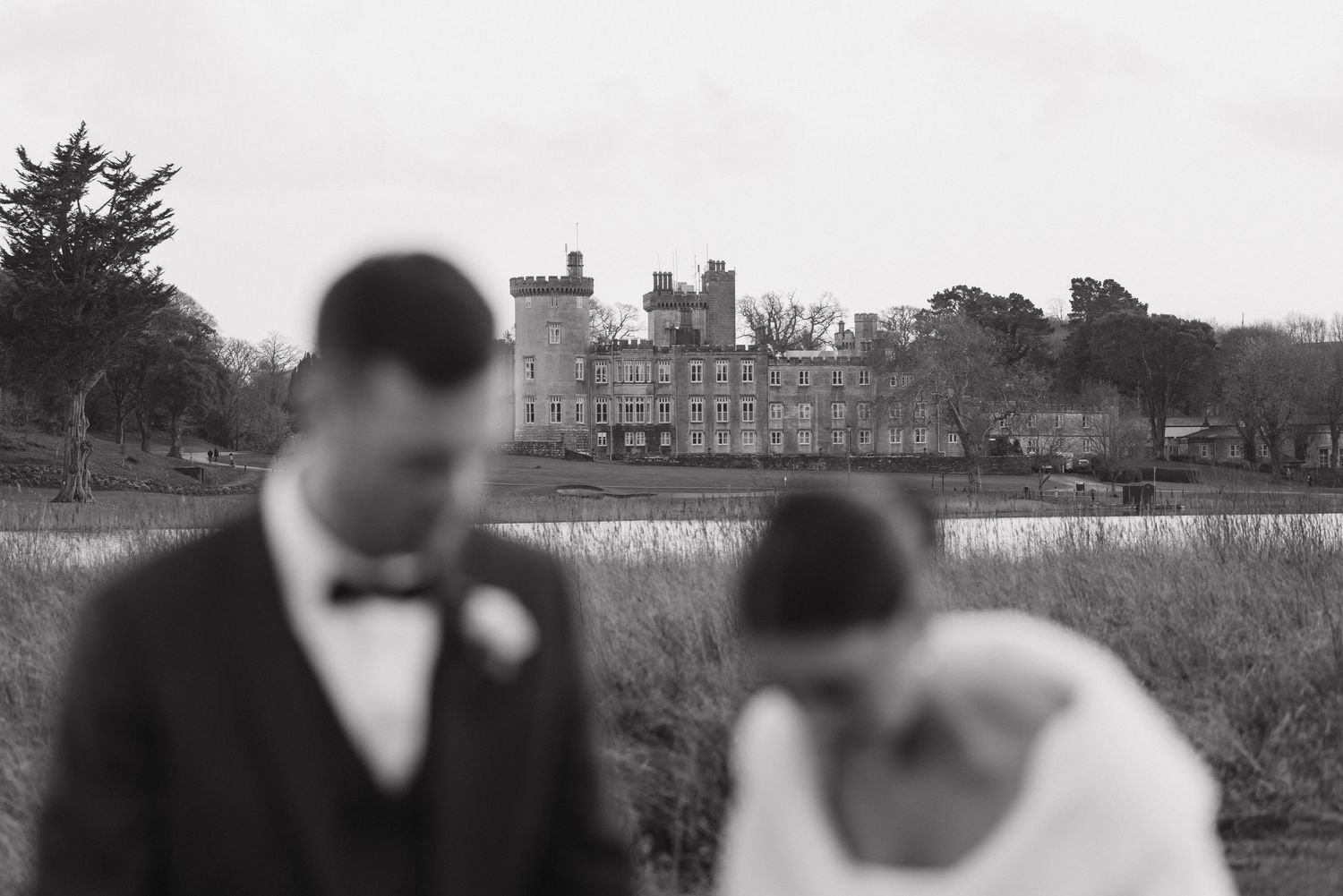 A grand castle estate serves as a romantic backdrop for outdoor wedding photography.