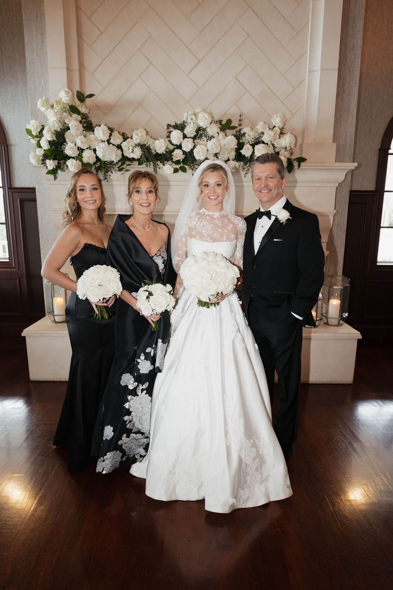 Wedding party members in black and white attire pose together for formal photos.