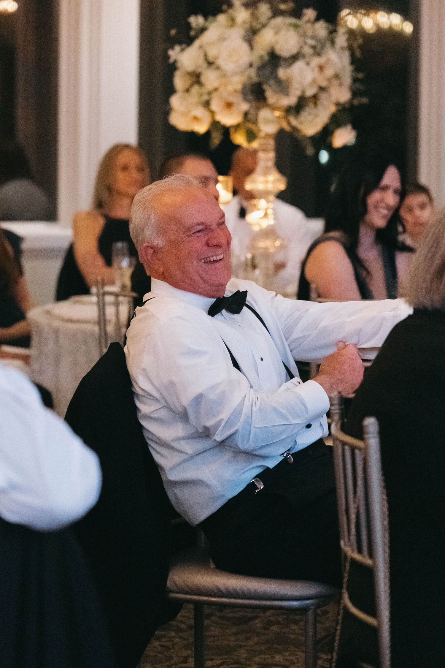 Wedding guest enjoying a lighthearted moment during the reception celebration.